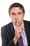 Green eyed businessman with finger to his lips