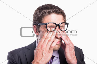 Close-up of a worried businessman rubbing eyes
