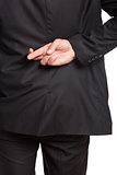 Mid section of a businessman with crossed fingers