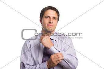 Young businessman adjusting shirt sleeves