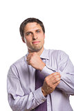 Portrait of a young businessman adjusting shirt sleeves