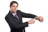 Portrait of a serious businessman showing his wristwatch