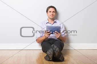 Businessman with digital tablet in an empty room