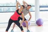 Two people doing power fitness exercise at yoga class