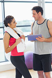 Fit couple with at digital table in exercise room