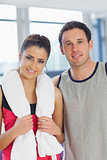 Portrait of a fit young couple in a exercise room