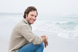 Smiling casual young man relaxing at beach