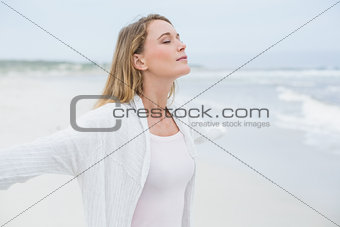 Peaceful casual woman with eyes closed at beach