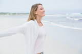 Casual young woman with eyes closed at beach