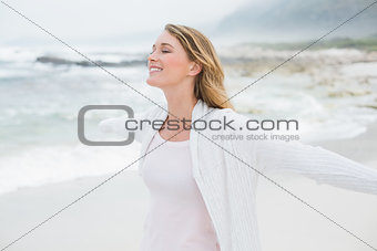 Casual young woman with eyes closed at beach