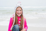Cute little girl in warm clothing at beach
