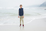 Full length of a cute smiling boy at beach