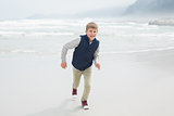 Cute smiling boy running at beach