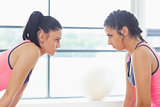 Two angry women staring at each other at a gym