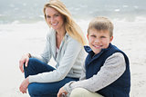 Casual woman and son relaxing at beach