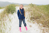 Full length portrait of a smiling girl at beach