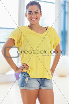 Portrait of a smiling fit young woman in yellow top