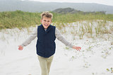 Cheerful young boy running at beach
