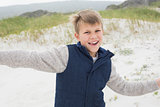 Cheerful boy running at beach