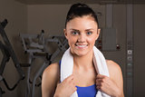 Close-up of a smiling woman with towel in gym
