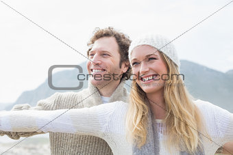 Casual young couple stretching hands out outdoors