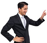 Smiling asian businessman pointing