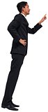 Unsmiling asian businessman pointing