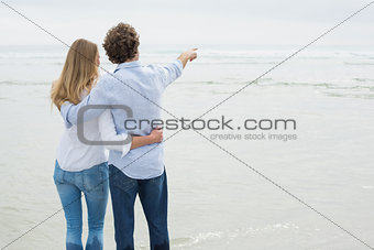Rear view of a couple looking at sea