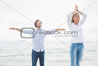 Peaceful couple with eyes closed at beach