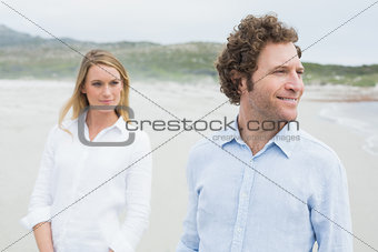 Smiling casual young couple at beach