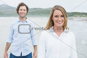 Smiling casual young couple at beach