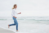 Side view of a woman running at beach