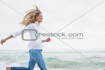 Side view of a woman running at beach