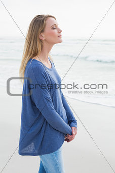 Peaceful woman with eyes closed at beach