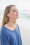 Casual woman with eyes closed at beach