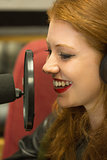 Pretty redhead student presenting a radio show