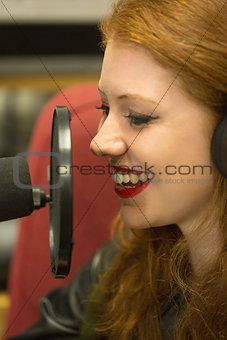 Pretty redhead student presenting a radio show