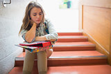 Upset student sitting on stairs