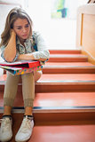 Troubled student sitting on stairs