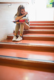 Upset student sitting on stairs