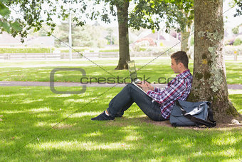 Young student using laptop outside