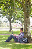 Young student using his laptop outside