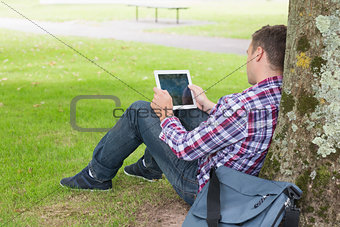 Student using his tablet pc outside