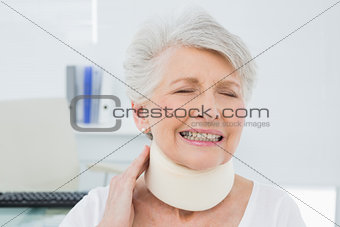 Senior woman wearing cervical collar with eyes closed