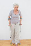 Full length of a senior woman with crutches