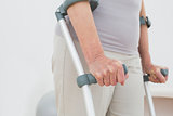 Close-up mid section of a woman with crutches