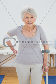 Portrait of a senior woman with crutch