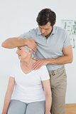Senior woman getting the neck adjustment done