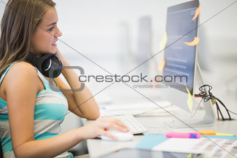 Pretty young student working in the computer room