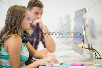 Classmates doing an assignment together in the computer room